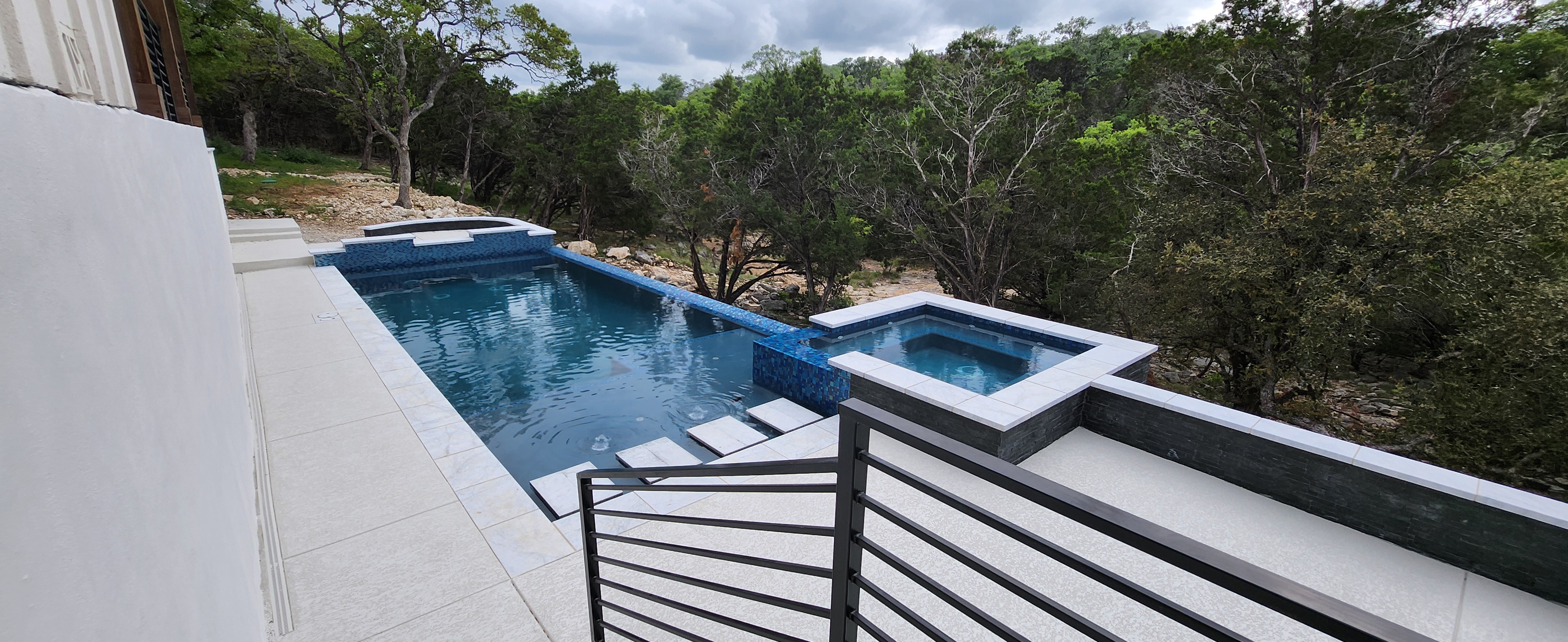 Exposed limestone rock shelf beside a New Braunfels pool excavation — the hidden cost behind vague rock clauses